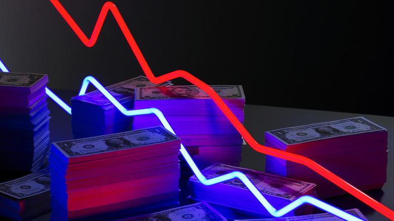 Neon lines in front of money representing a loss in profits