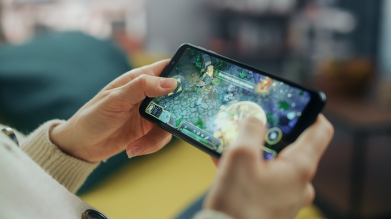 Person playing a game on the phone