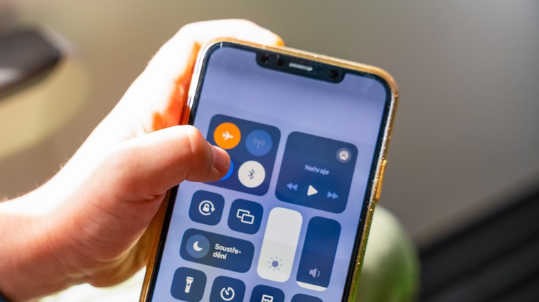 A person using Airplane Mode on an iPhone.