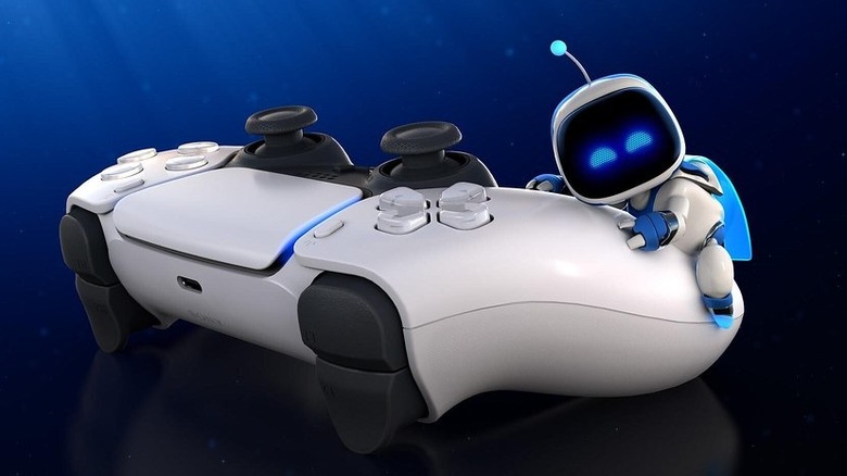 Astro Bot hugging a white PS5 controller on a blue and black gradient background