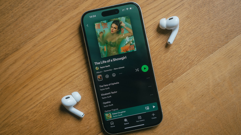 AirPods next to an iPhone playing music.