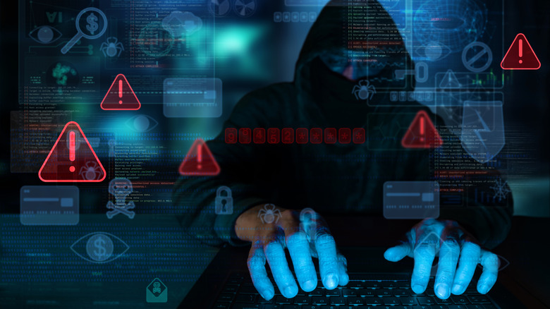 a cybercriminal showing hacking in illegally through a laptop
