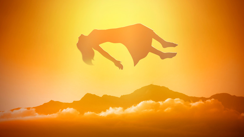 woman's soul floating into a golden sky