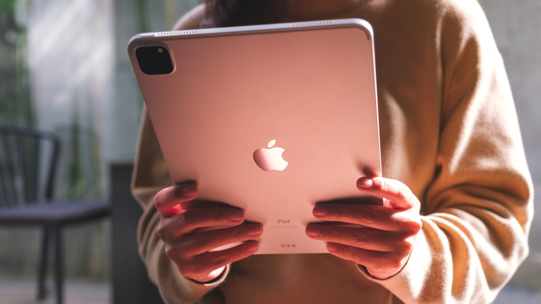 Someone holding a pink iPad