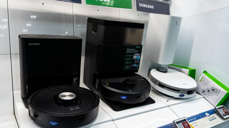 a variety of robot vacuums sitting on store shelves