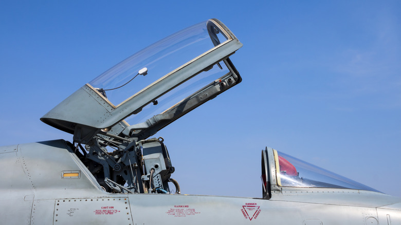 Close-up of fighter jet canopy and ejection seat
