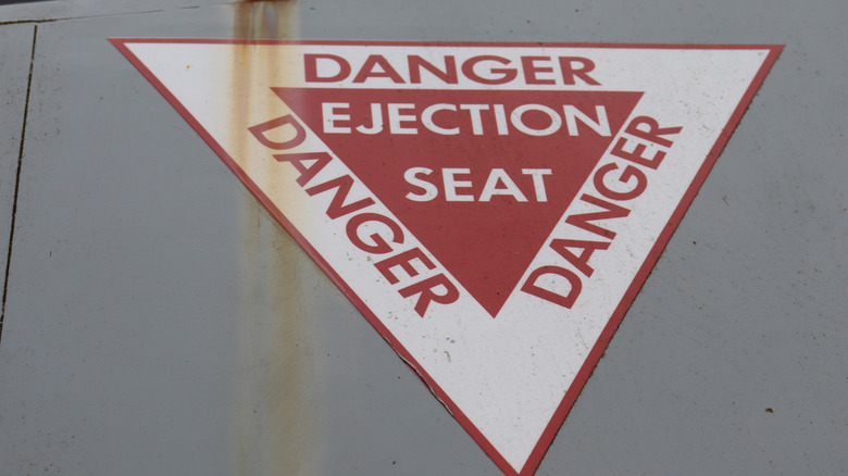 Close-up of ejection seat warning sign