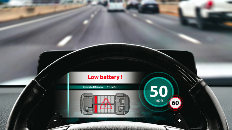 A low battery warning on an EV dashboard.