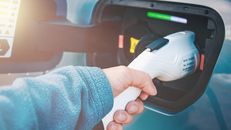 Electric or hybrid vehicle plugged into a charging cable