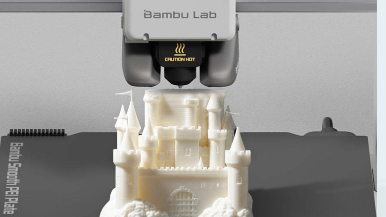 Bambu Lab 3D printer constructing a white castle print with PLA filament