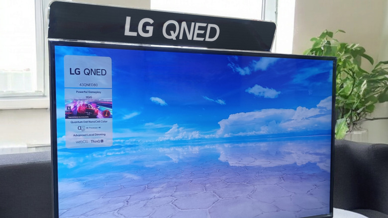 An LG QLED TV displayed in what looks like an apartment setting.