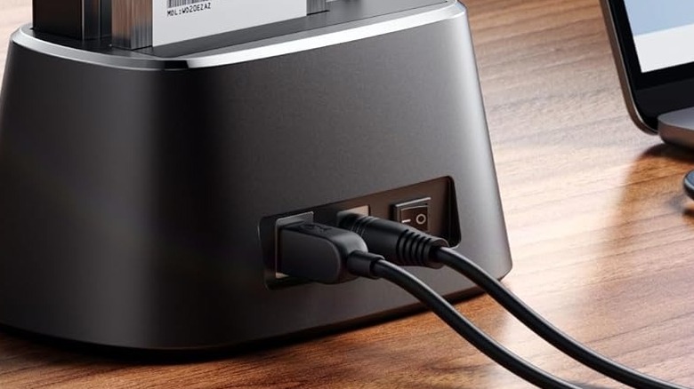 A USB-B connector plugged into a hard drive dock.