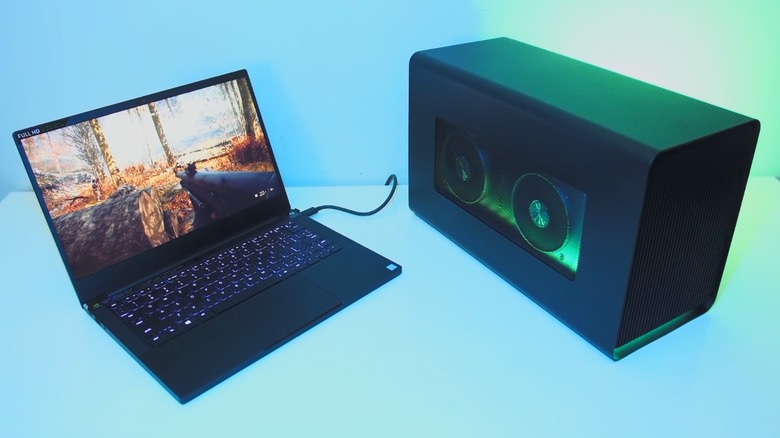 A laptop plugged into an external graphics card dock