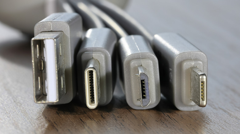 Four different types of USB cables. From left to right: USB-A, USB-C, Micro USB, and Lightning.