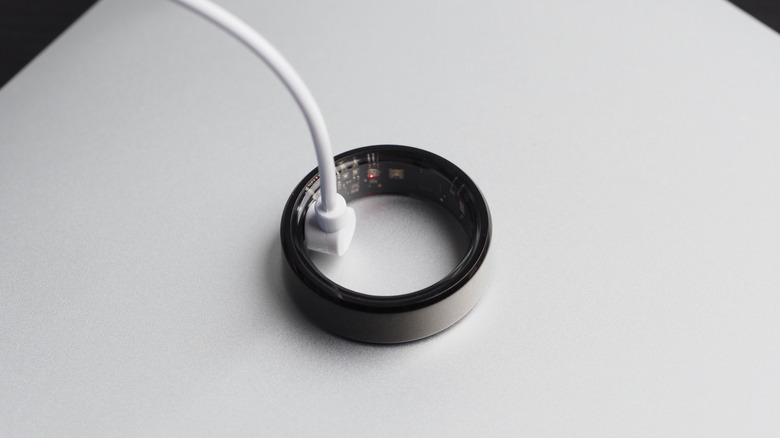 A smart ring being charged through a cable.