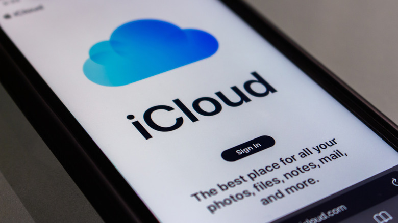 An iPhone on an angle showing the iCloud app sign-in page.