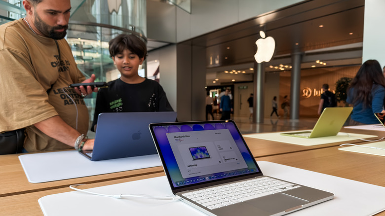 Apple Store customers testing out the MacBook Neo.