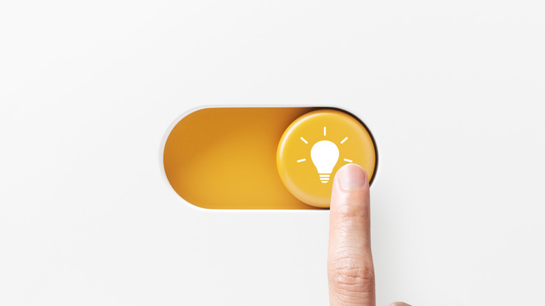 A finger toggling on a digital button