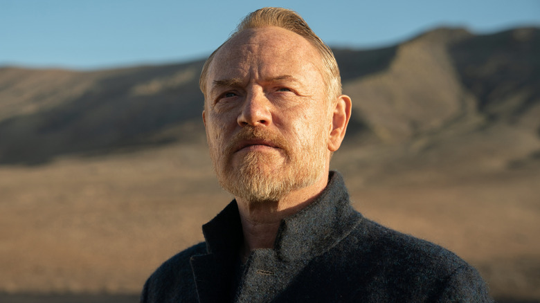 Hari Seldon standing in front of a mountain range in 