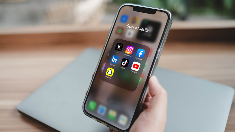 An iphone showing social media apps open in a grid view