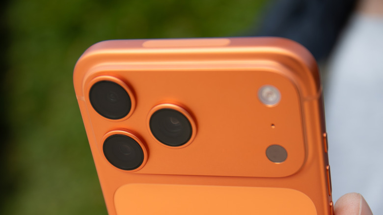 Close-up view of an iPhone 17 Pro's rear camera and top antenna window.