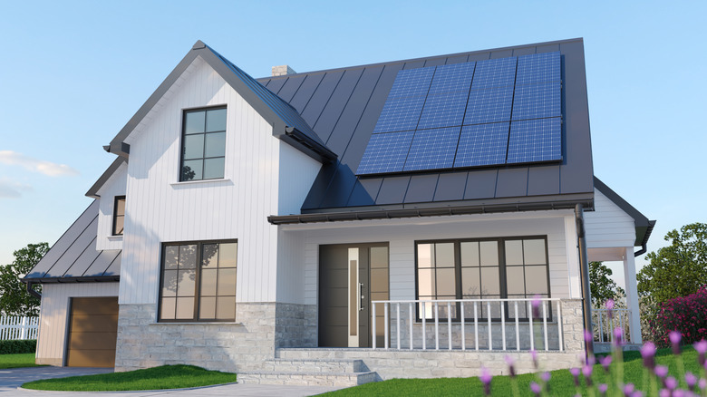 A modern single-family home with solar panels on the roof.