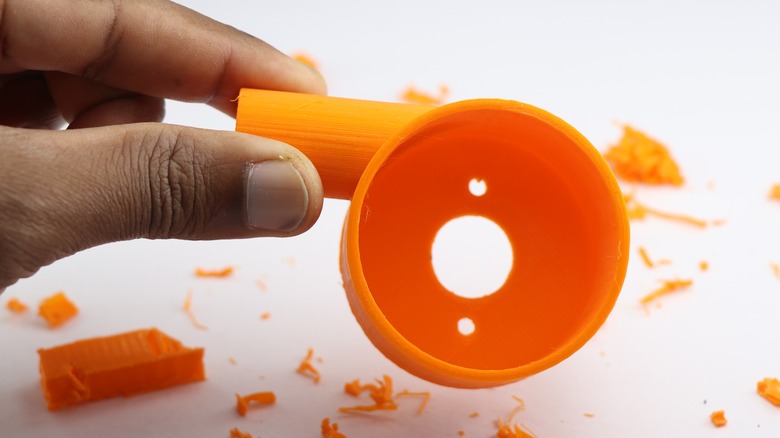 Hand holding 3D printed project after the printing process.