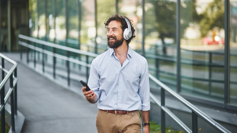 A person wearing headphones outside