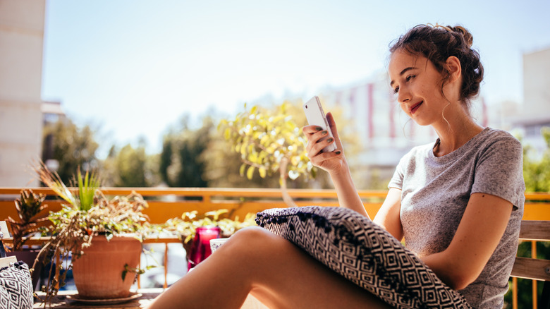 person using phone on sunny day