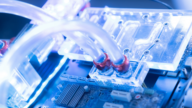 A custom liquid cooling loop for a PC with transparent tubes and parts.