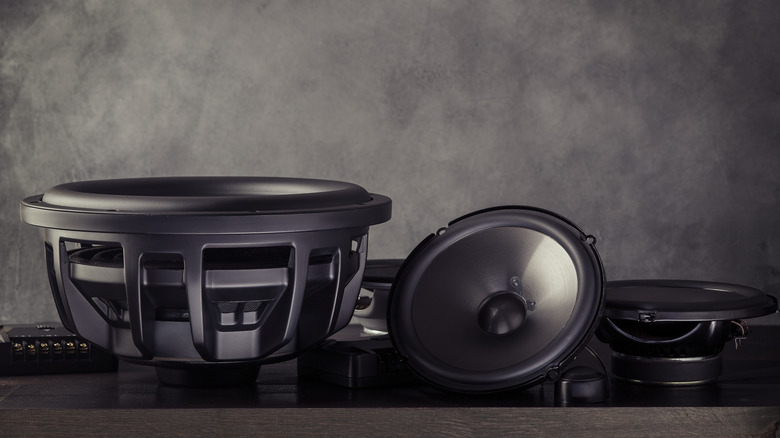 Shallow mount subwoofer sitting next to a set of speakers