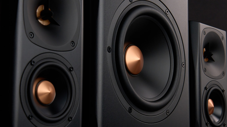 Closeup of black and bronze speakers and subwoofer
