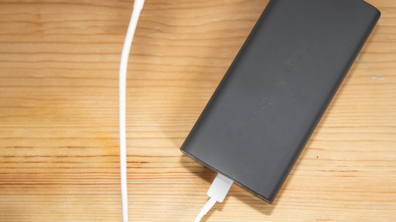 A USB-C cable connected to a portable power bank.