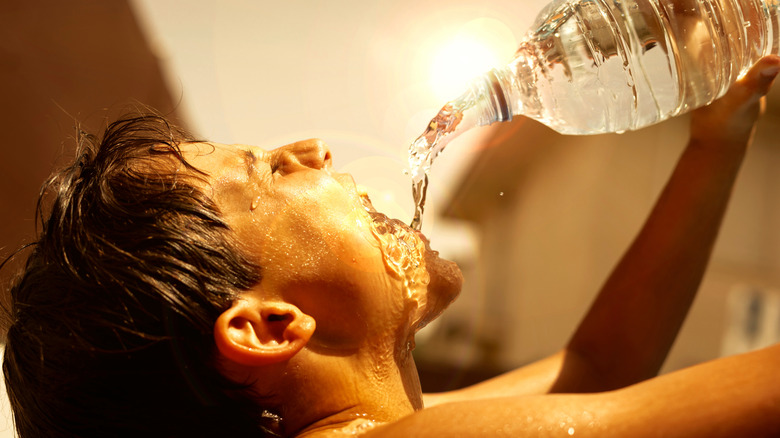 person drinking water in heat wave