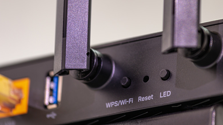 Close-Up of a black router showing the WPS button
