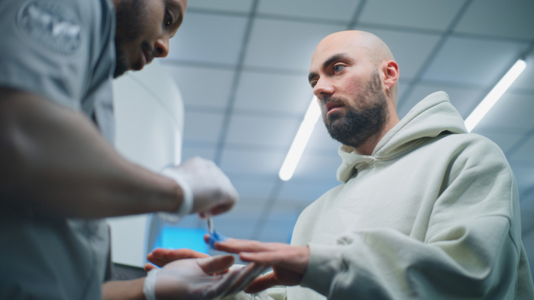 TSA security hand swab being conducted at a checkpoint.