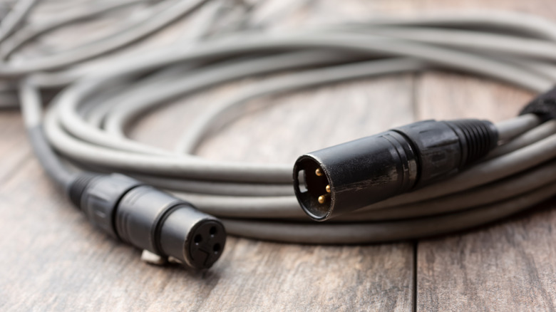 Close-up of XLR cable on top of wooden box