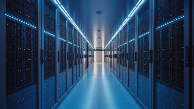 A large server room with racks visible and low lighting.