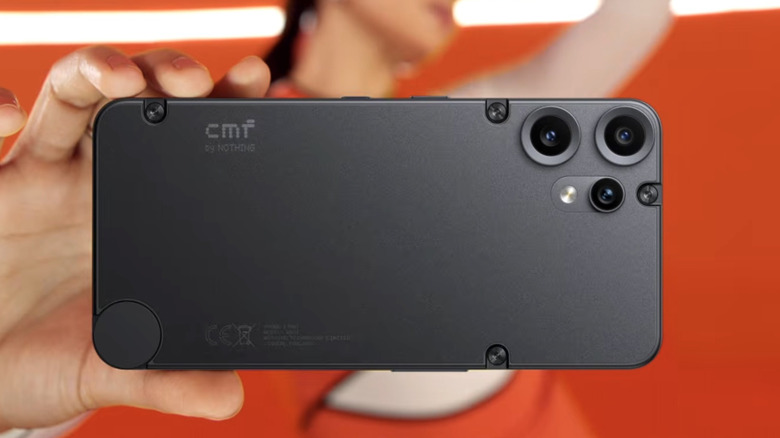 A woman holding Nothing's CMF Phone 2 Pro.
