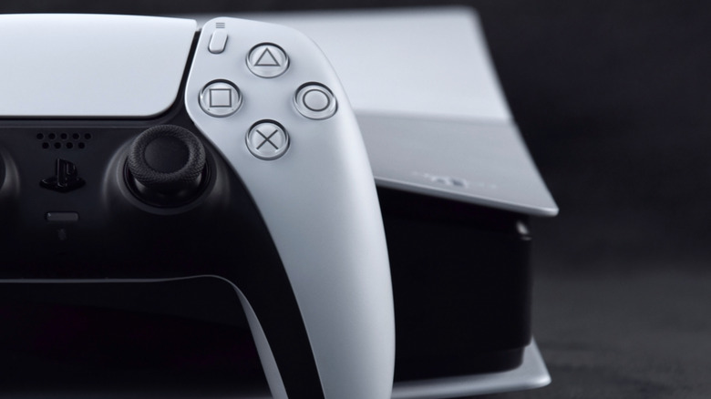 A close-up of a PlayStation 5 and a DualSense controller.