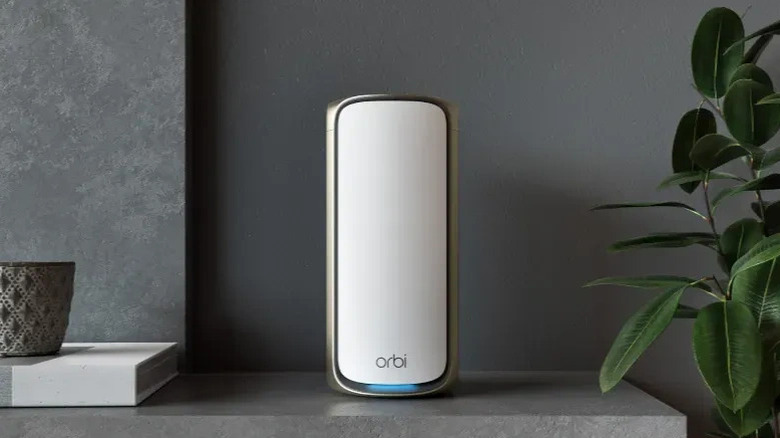 A white Netgear Orbi 970 Series router on a mantel.