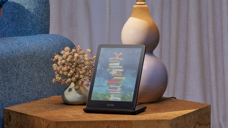 A Kindle Colorsoft Signature Edition e-reader on a charging dock on a living room table