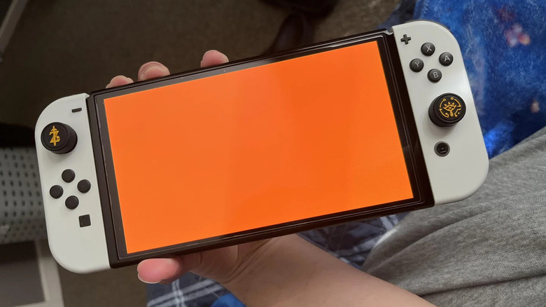 A Nintendo Switch with the orange screen of death