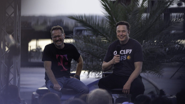 SpaceX founder Elon Musk sits with T-Mobile vice chairman Mike Sievert.