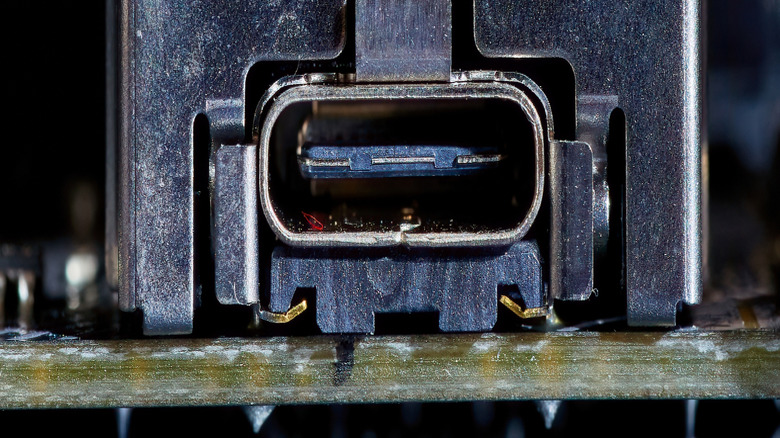 A close-up photograph of a teal USB port.