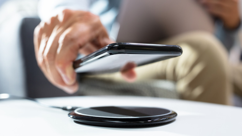 Close-Up of a person placing a phone on a wireless charger
