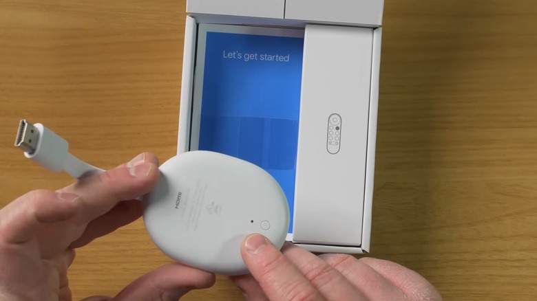 A user showing the back button on the Chromecast with Google TV model.