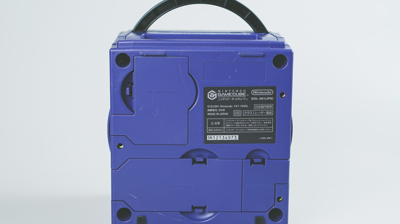 The bottom of a Nintendo GameCube console that shows a Japanese label and three covered ports
