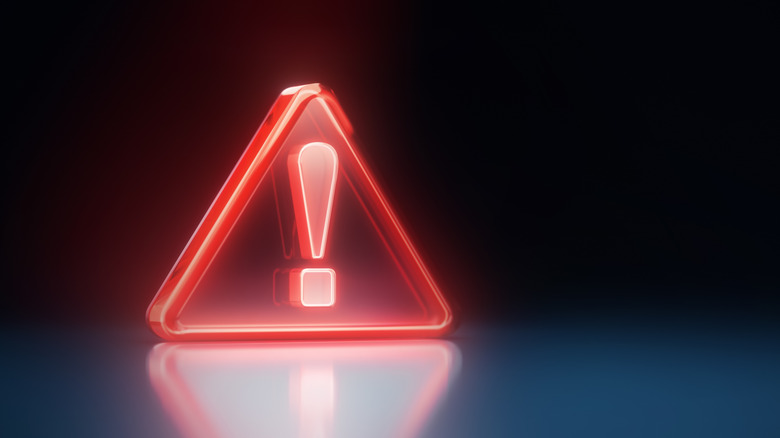 A glowing, red warning icon against a black background