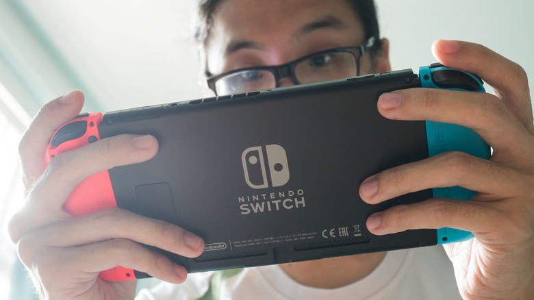 A man playing Nintendo Switch